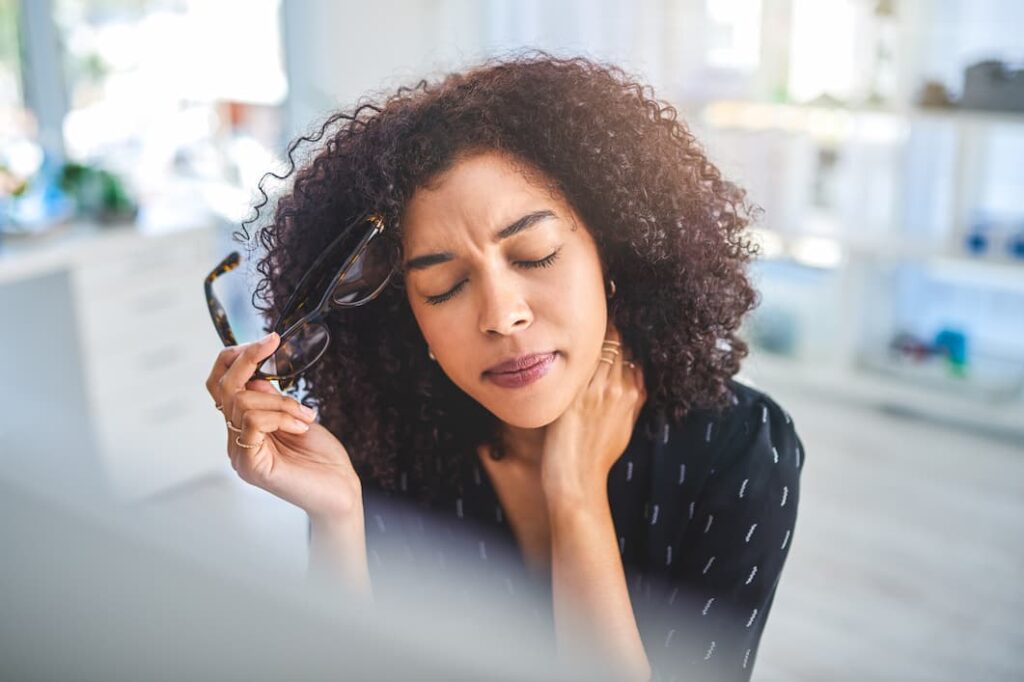 woman holding her neck in pain
