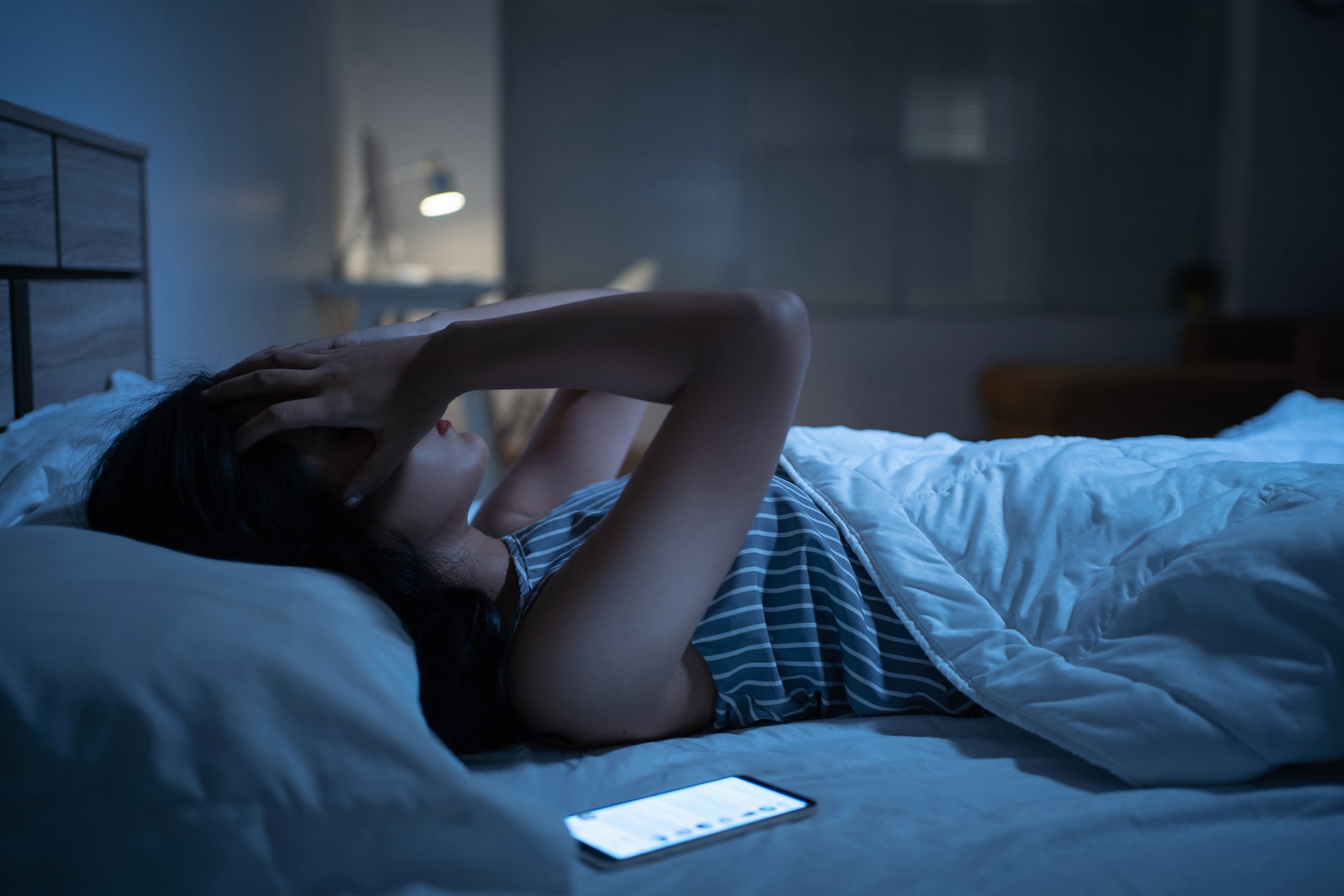 woman trying to sleep at night in her bed