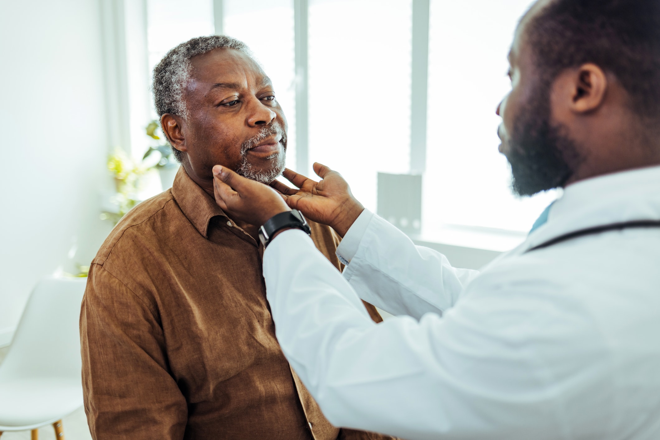 man examining a man's throat