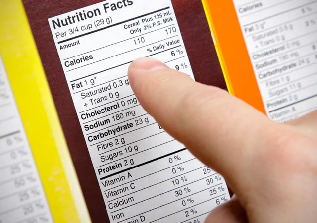 person pointing to a Nutrition label