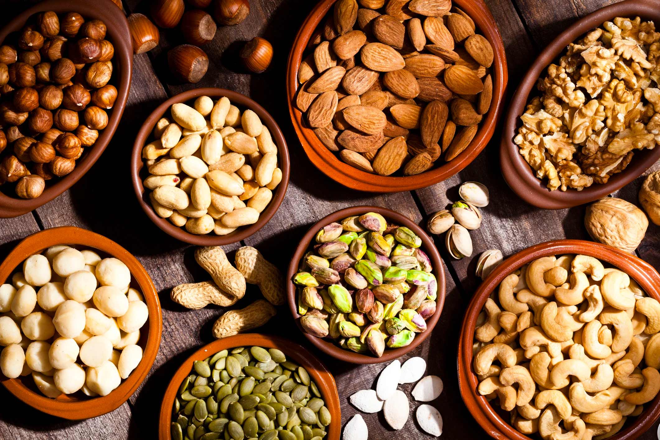 assortments of nuts in bowls next to each other
